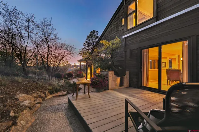 a living room with a bed and a potted plant
