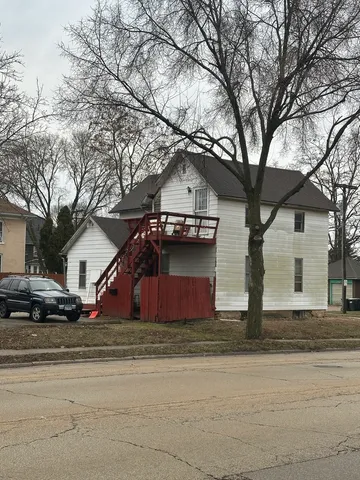 a front view of house with yard and trees