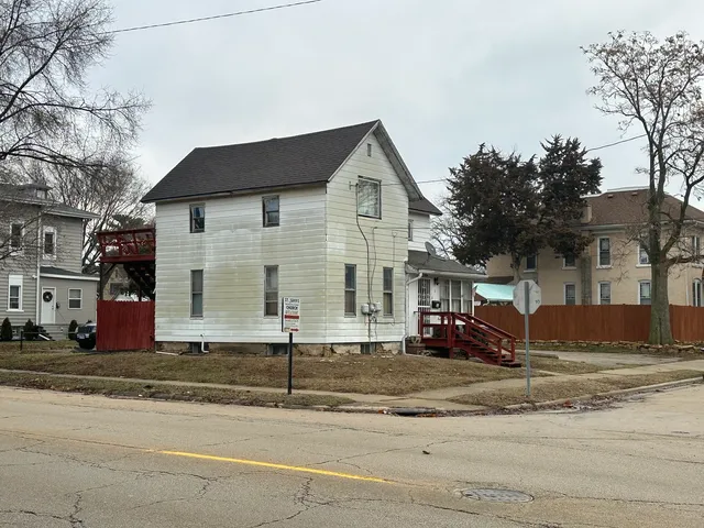 a front view of a house with a road