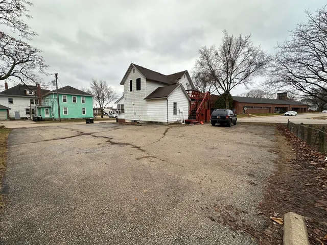 a view of a house with a yard covered in snow