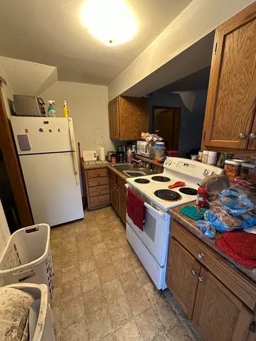 a kitchen with a stove and a refrigerator
