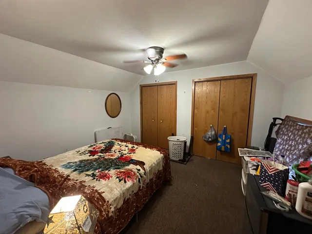 a bedroom with bed and a chandelier