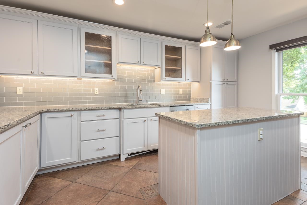 8364 Bazemore Road Cordova, TN 38018 - Photo 14 of 33 a kitchen with granite countertop cabinets stainless steel appliances a sink and a window