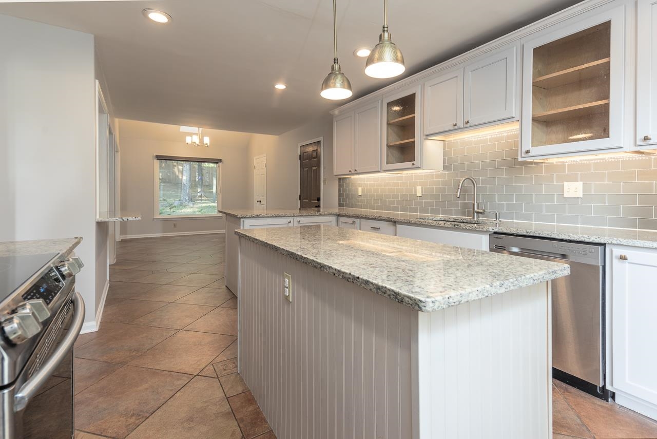 8364 Bazemore Road Cordova, TN 38018 - Photo 17 of 33 a kitchen with kitchen island granite countertop a sink and a stove