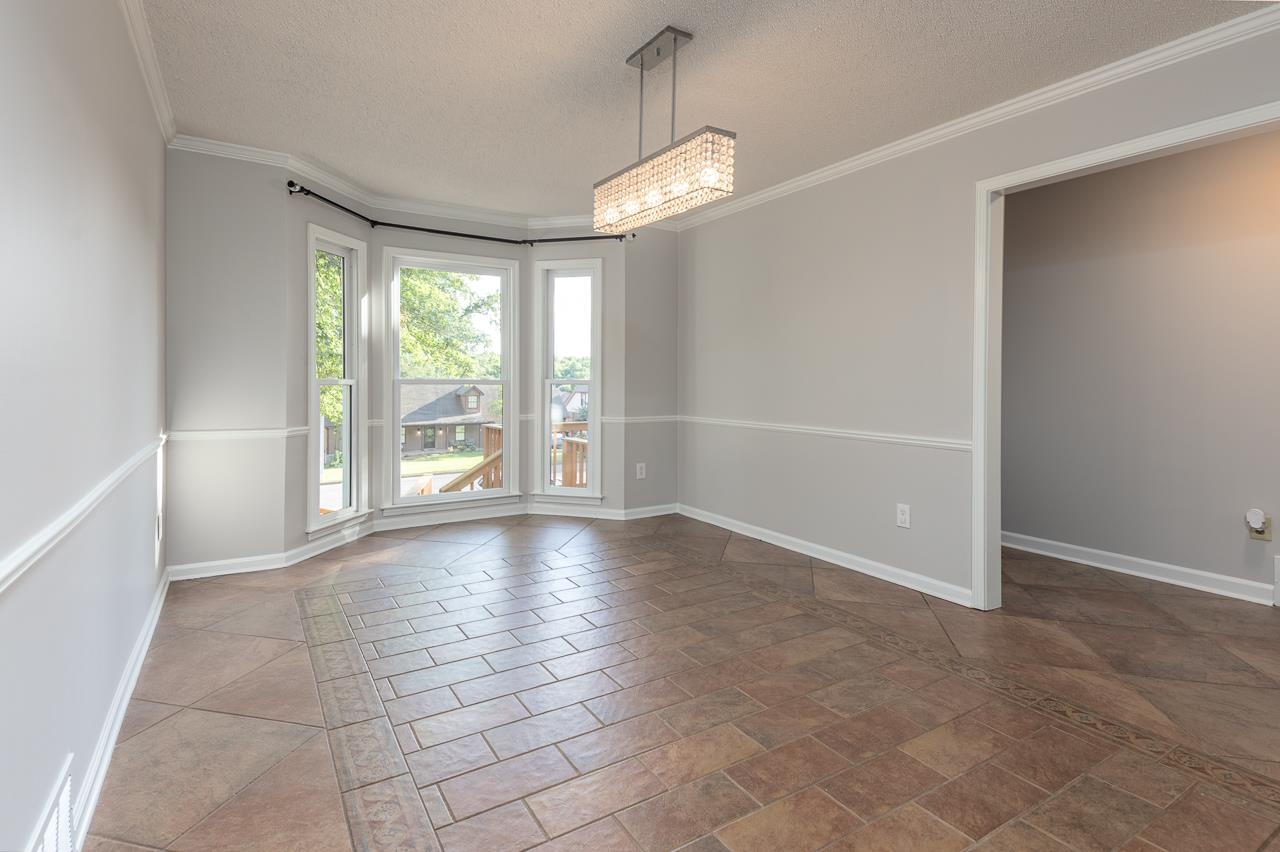 8364 Bazemore Road Cordova, TN 38018 - Photo 19 of 33 an empty room with floor to ceiling windows and an empty room