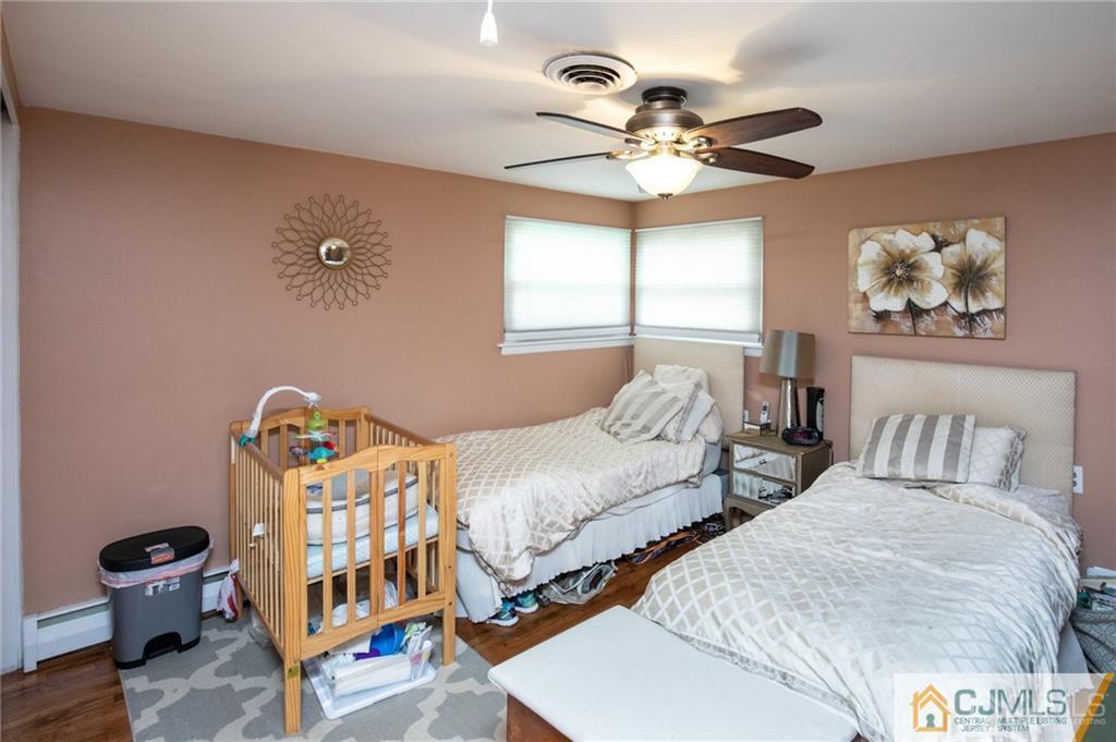 19 Eardley Road Edison, NJ 08817 - Photo 11 of 25 a bedroom with furniture and a chandelier