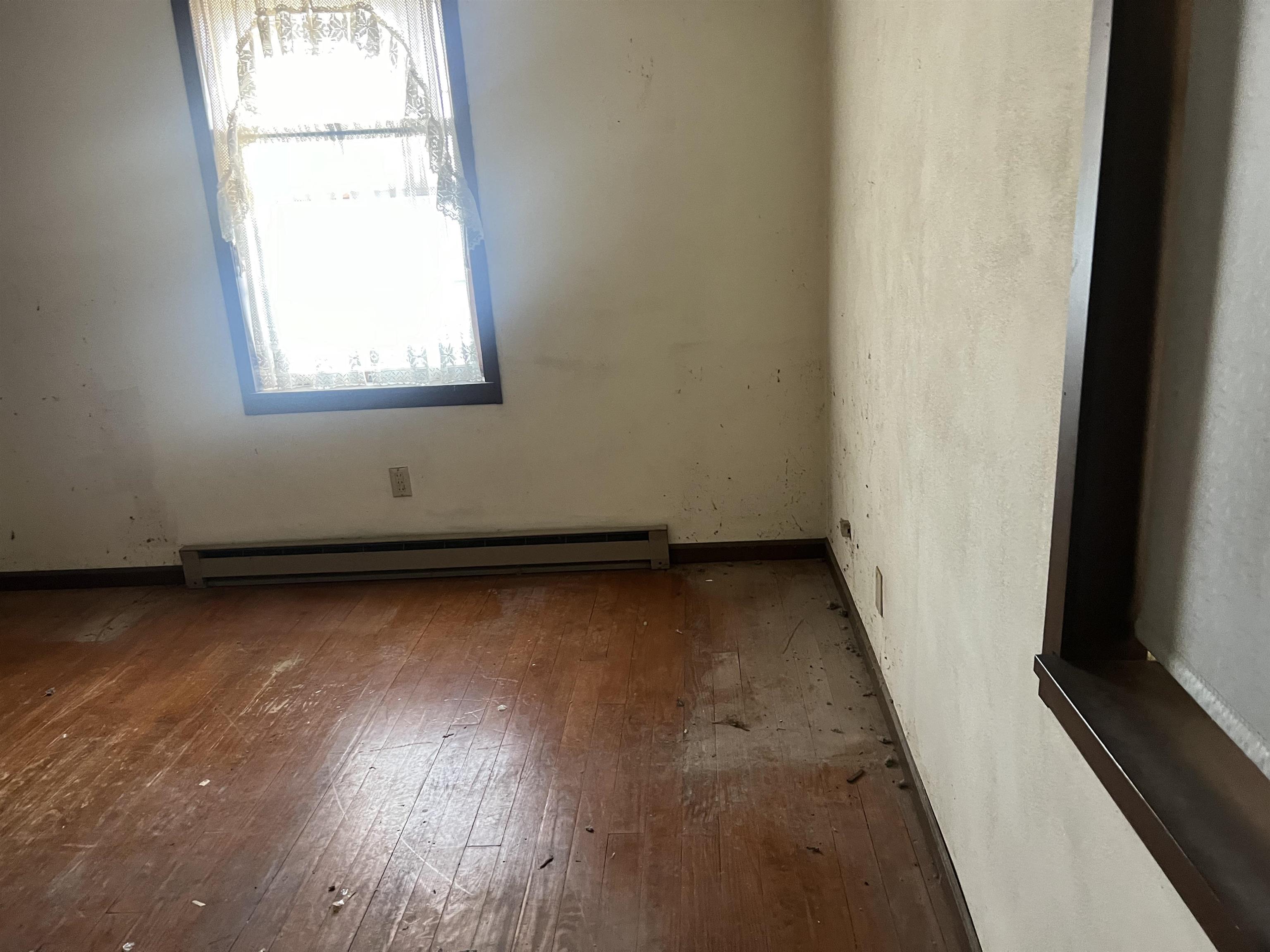8282 North Afolkey Road Dakota, IL 61018 - Photo 16 of 42 an empty room with wooden floor and windows