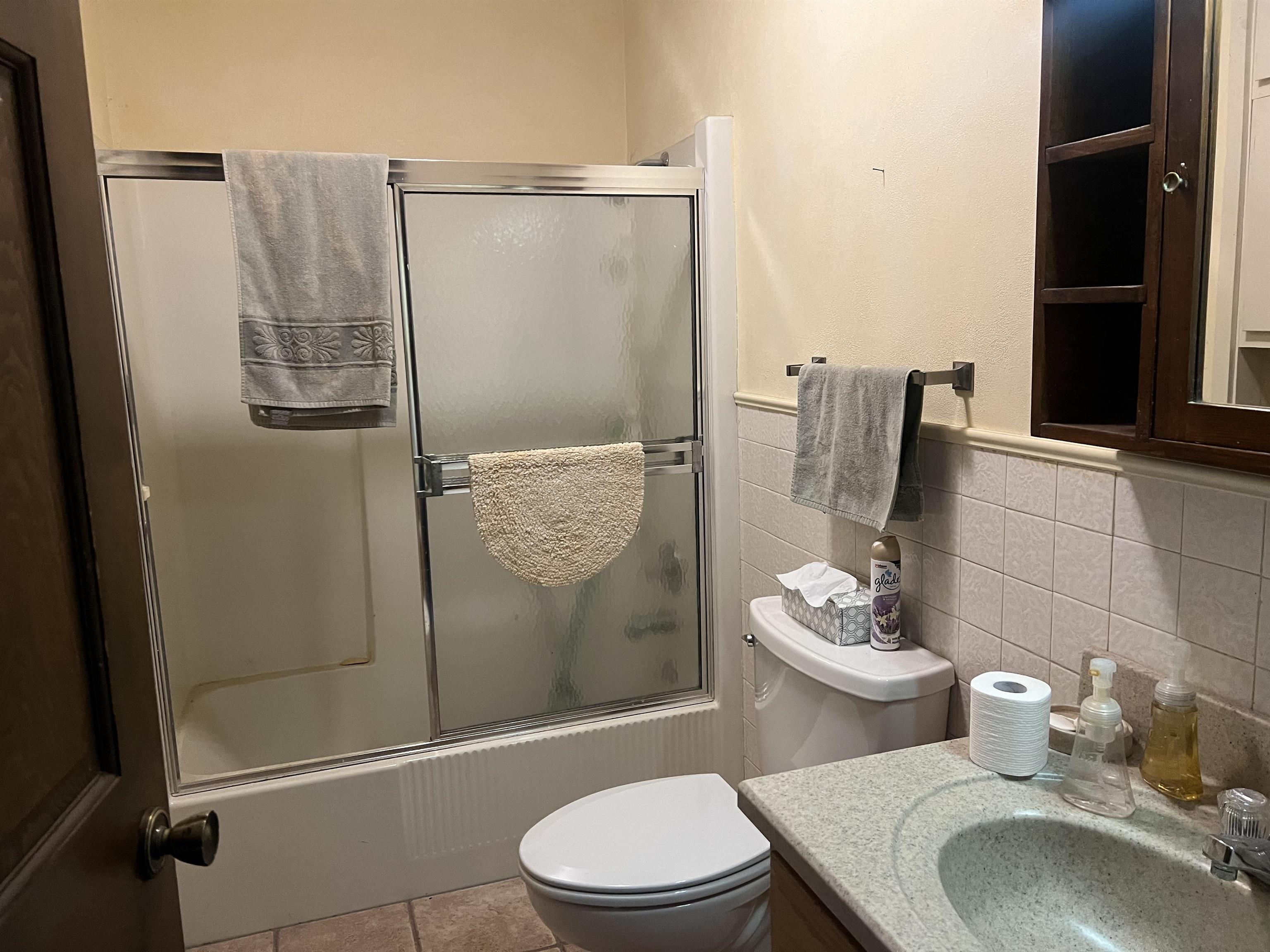8282 North Afolkey Road Dakota, IL 61018 - Photo 17 of 42 a bathroom with a toilet a sink and shower
