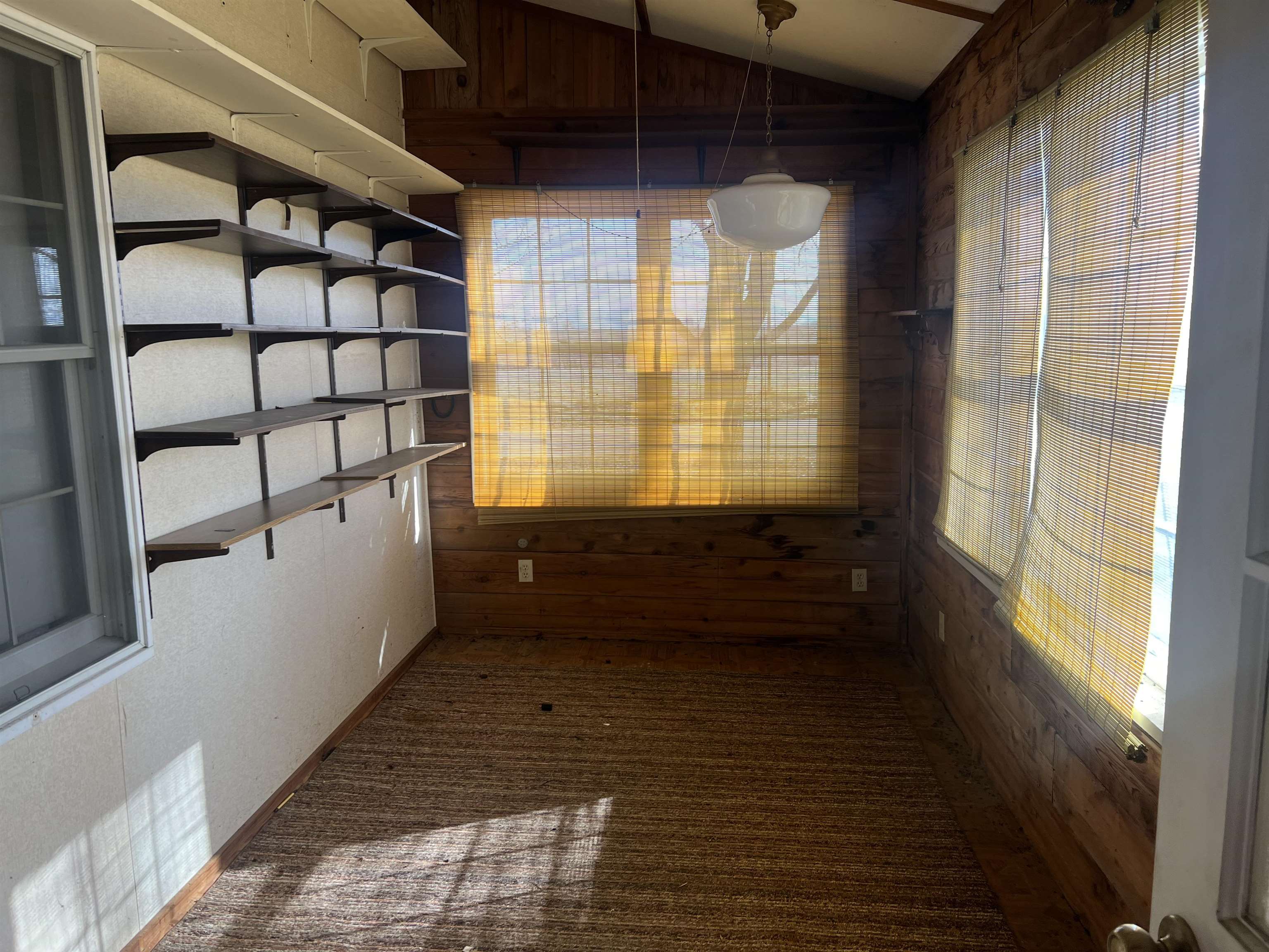 8282 North Afolkey Road Dakota, IL 61018 - Photo 3 of 42 a view of empty room with wooden floor and fan