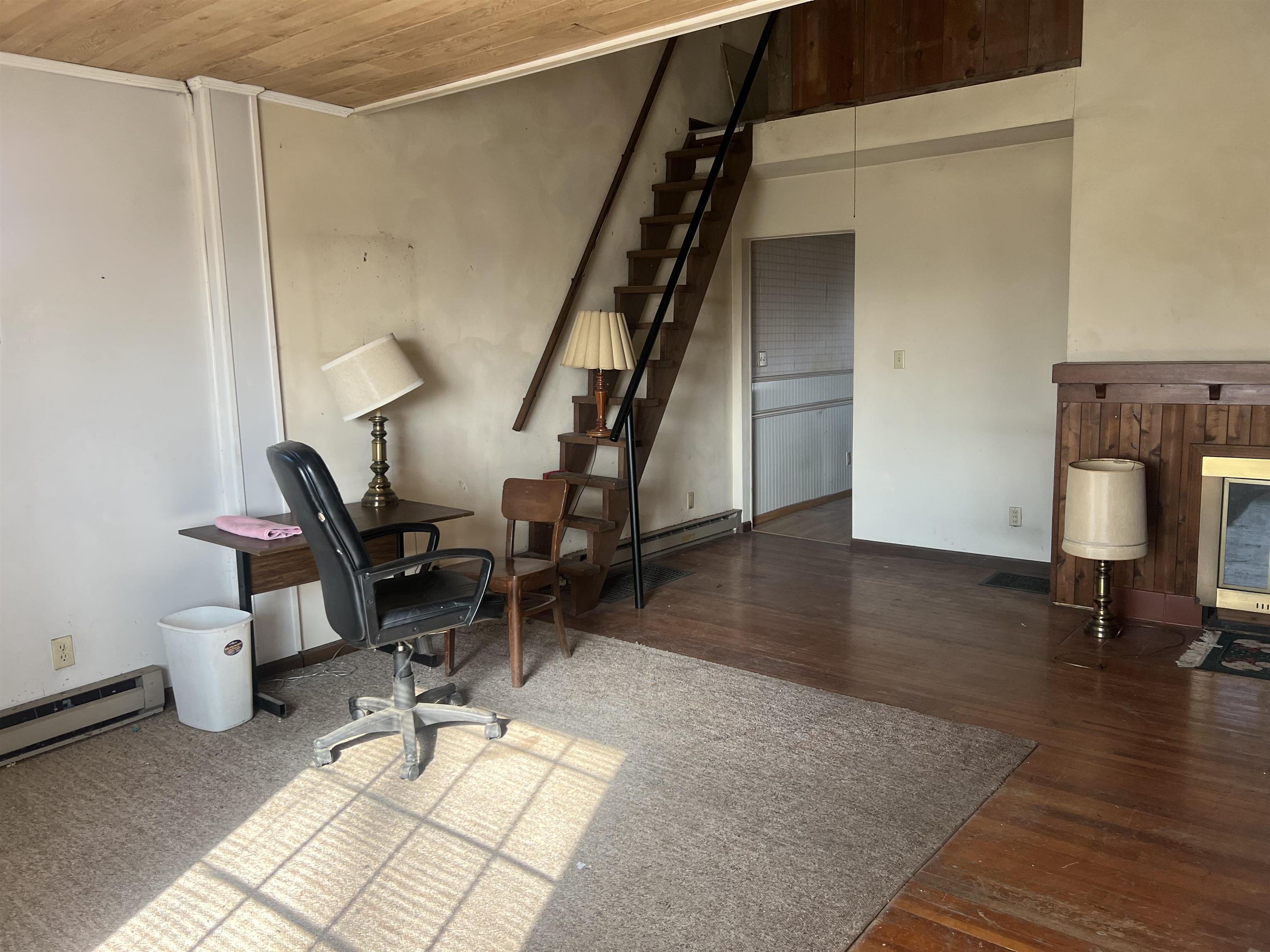 8282 North Afolkey Road Dakota, IL 61018 - Photo 4 of 42 a view of a livingroom with wooden floor and furniture