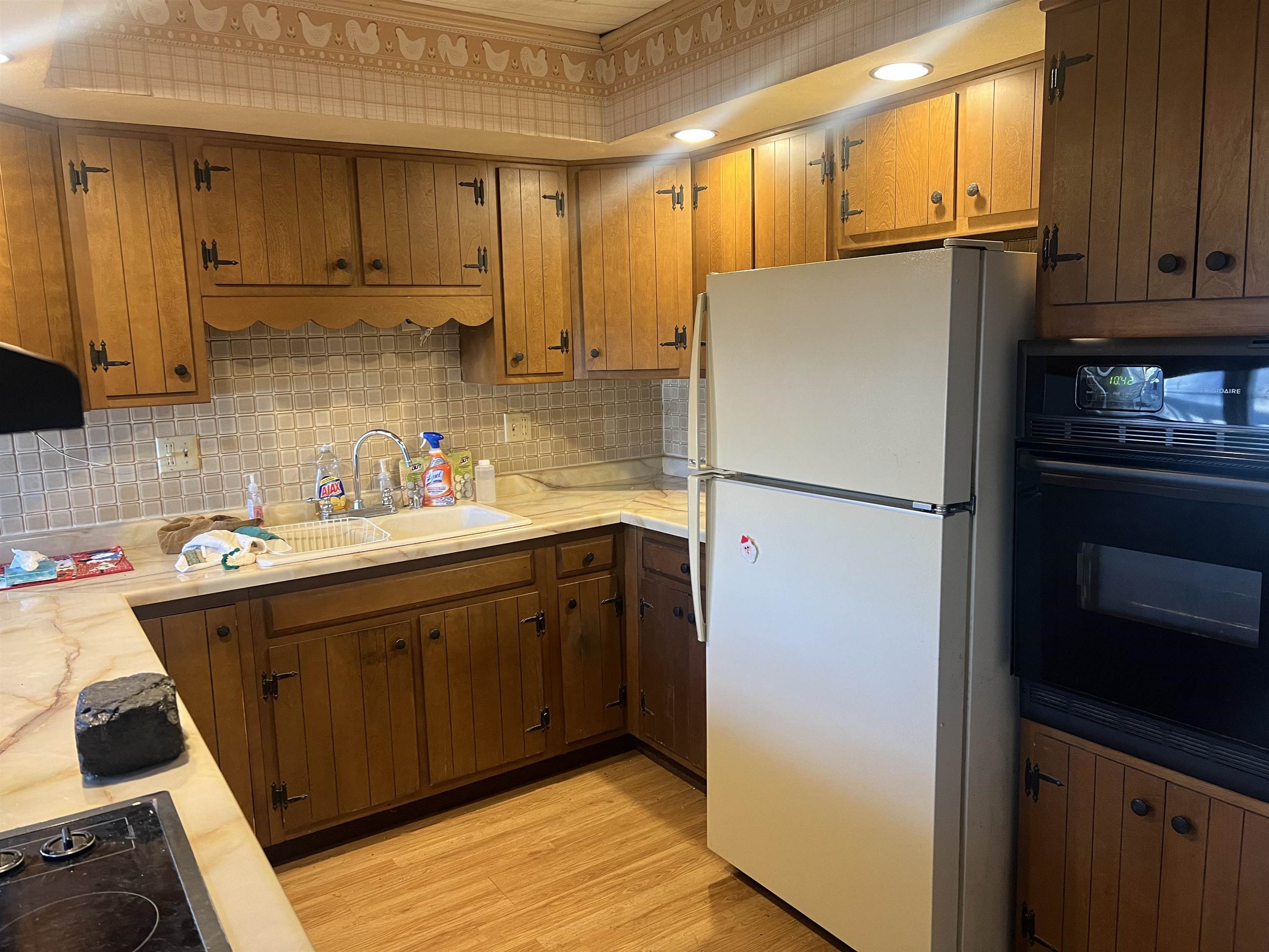 8282 North Afolkey Road Dakota, IL 61018 - Photo 8 of 42 a kitchen with a refrigerator sink and cabinets