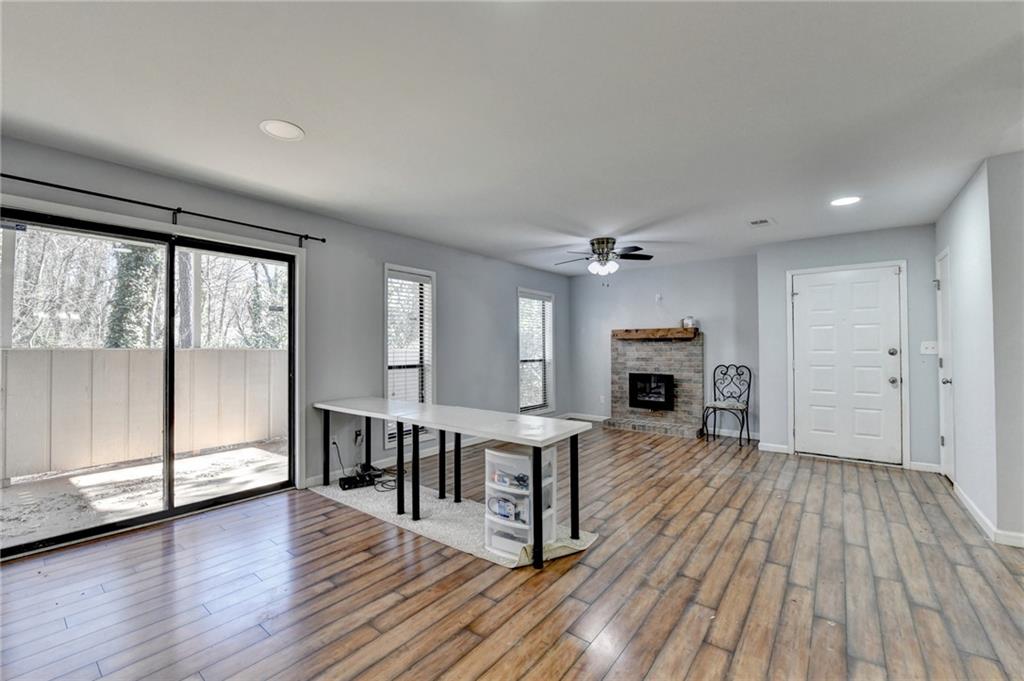 516 Wynnes Ridge Circle Southeast, Unit 516 Marietta, GA 30067 - Photo 11 of 40 a view of a livingroom with furniture wooden floor fireplace and windows