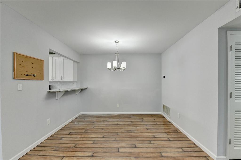 516 Wynnes Ridge Circle Southeast, Unit 516 Marietta, GA 30067 - Photo 12 of 40 a view of a room with wooden floor and cabinet
