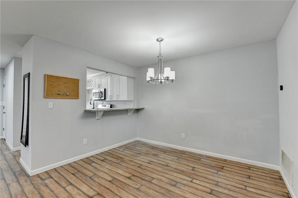 516 Wynnes Ridge Circle Southeast, Unit 516 Marietta, GA 30067 - Photo 13 of 40 a view of a room with wooden floor and a ceiling fan