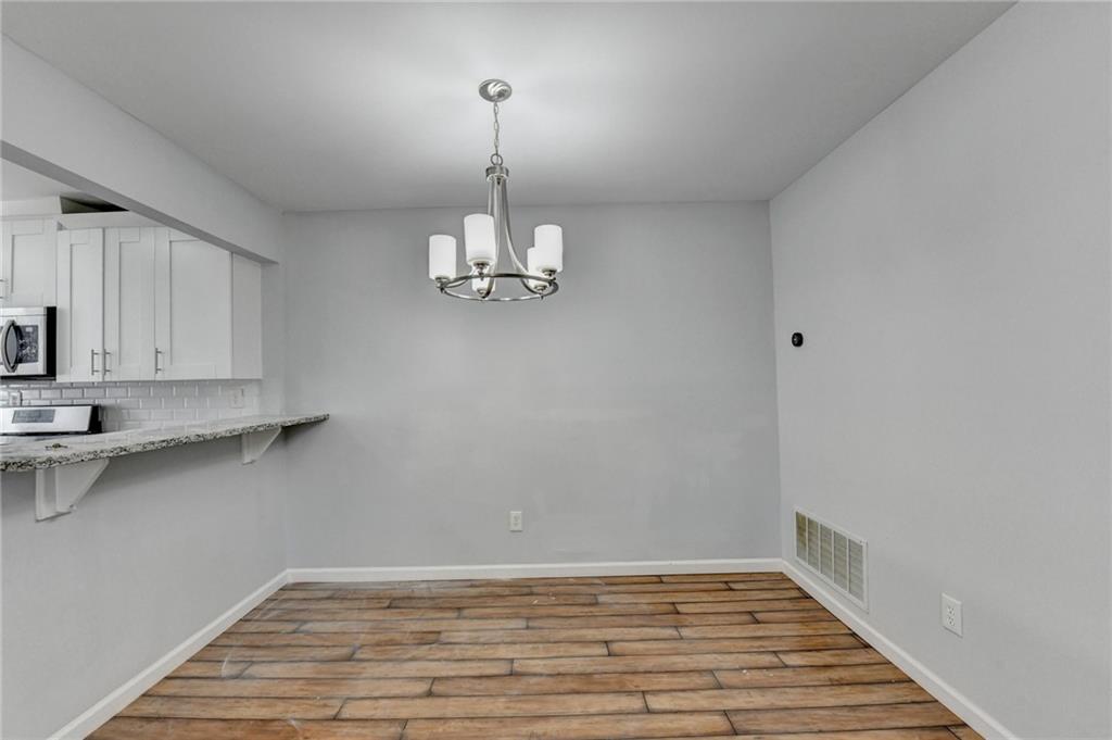 516 Wynnes Ridge Circle Southeast, Unit 516 Marietta, GA 30067 - Photo 16 of 40 a view of a kitchen with a sink and cabinets