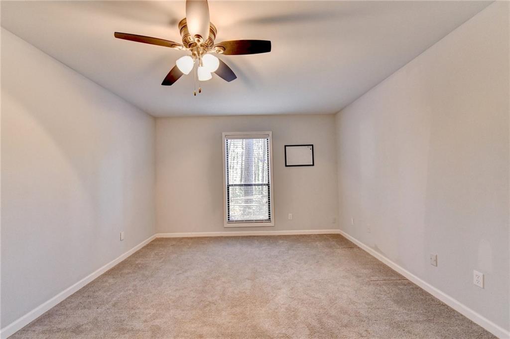516 Wynnes Ridge Circle Southeast, Unit 516 Marietta, GA 30067 - Photo 24 of 40 an empty room with windows and ceiling fan