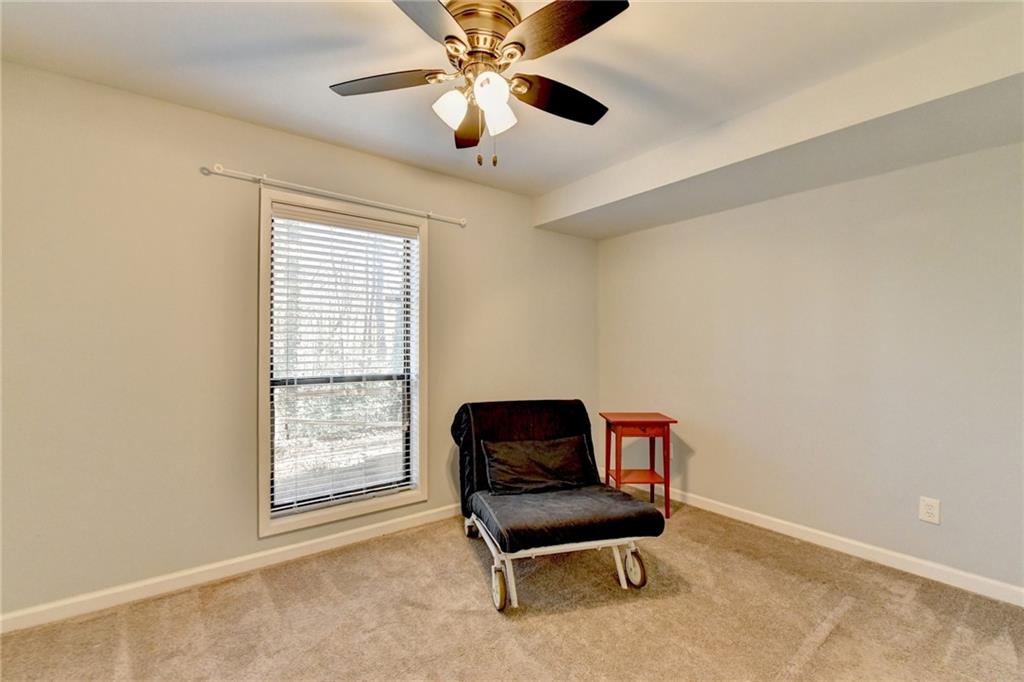 516 Wynnes Ridge Circle Southeast, Unit 516 Marietta, GA 30067 - Photo 31 of 40 a living room with furniture and a ceiling fan