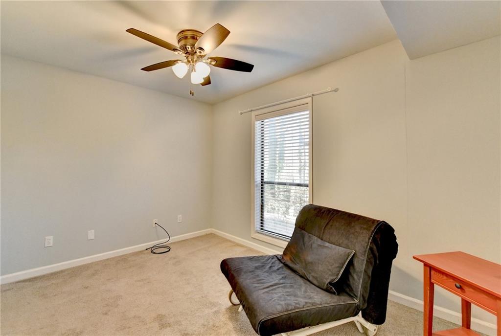 516 Wynnes Ridge Circle Southeast, Unit 516 Marietta, GA 30067 - Photo 33 of 40 a living room with furniture and a ceiling fan
