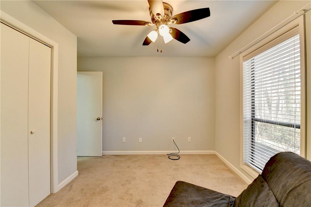 516 Wynnes Ridge Circle Southeast, Unit 516 Marietta, GA 30067 - Photo 34 of 40 a view of a livingroom with a ceiling fan and window