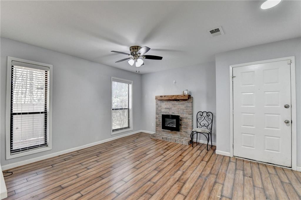 516 Wynnes Ridge Circle Southeast, Unit 516 Marietta, GA 30067 - Photo 8 of 40 an empty room with wooden floor fireplace and windows