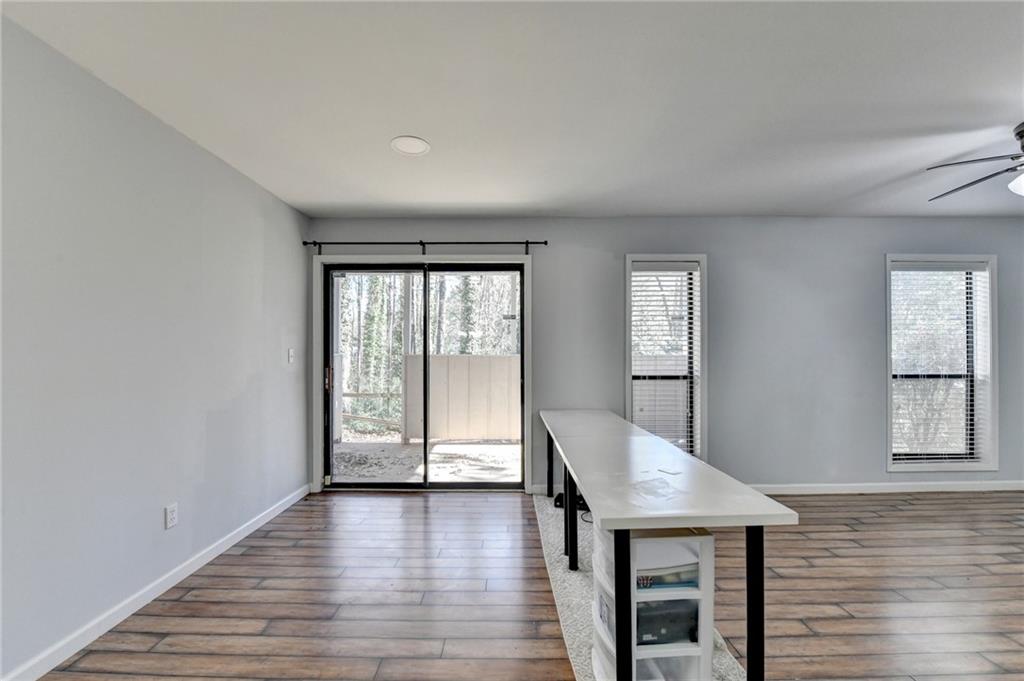516 Wynnes Ridge Circle Southeast, Unit 516 Marietta, GA 30067 - Photo 10 of 40 wooden floor in an empty room with a window