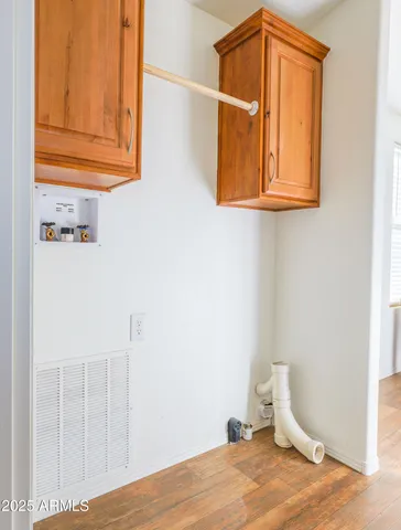 a view of a room with wooden floor and cabinet