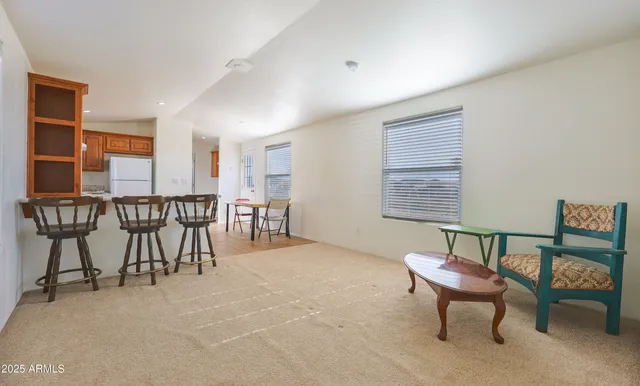 a view of a livingroom with furniture and a window