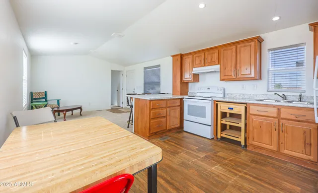 a large kitchen with stainless steel appliances granite countertop a sink and cabinets