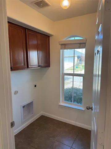 a view of a living room with kitchen and wooden floor