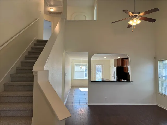 a view of a livingroom with a ceiling fan and wooden floor