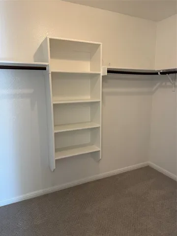 a large kitchen with stainless steel appliances granite countertop a stove a sink and a refrigerator