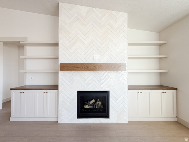 533 West S Temple Street, Unit 309 Tooele, UT 84074 - Photo 9 of 24 Detailed view of wood finished floors and a tile fireplace