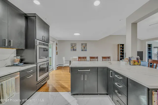 a kitchen with stainless steel appliances granite countertop a refrigerator and a stove