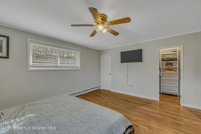 a view of a livingroom with a ceiling fan and a window