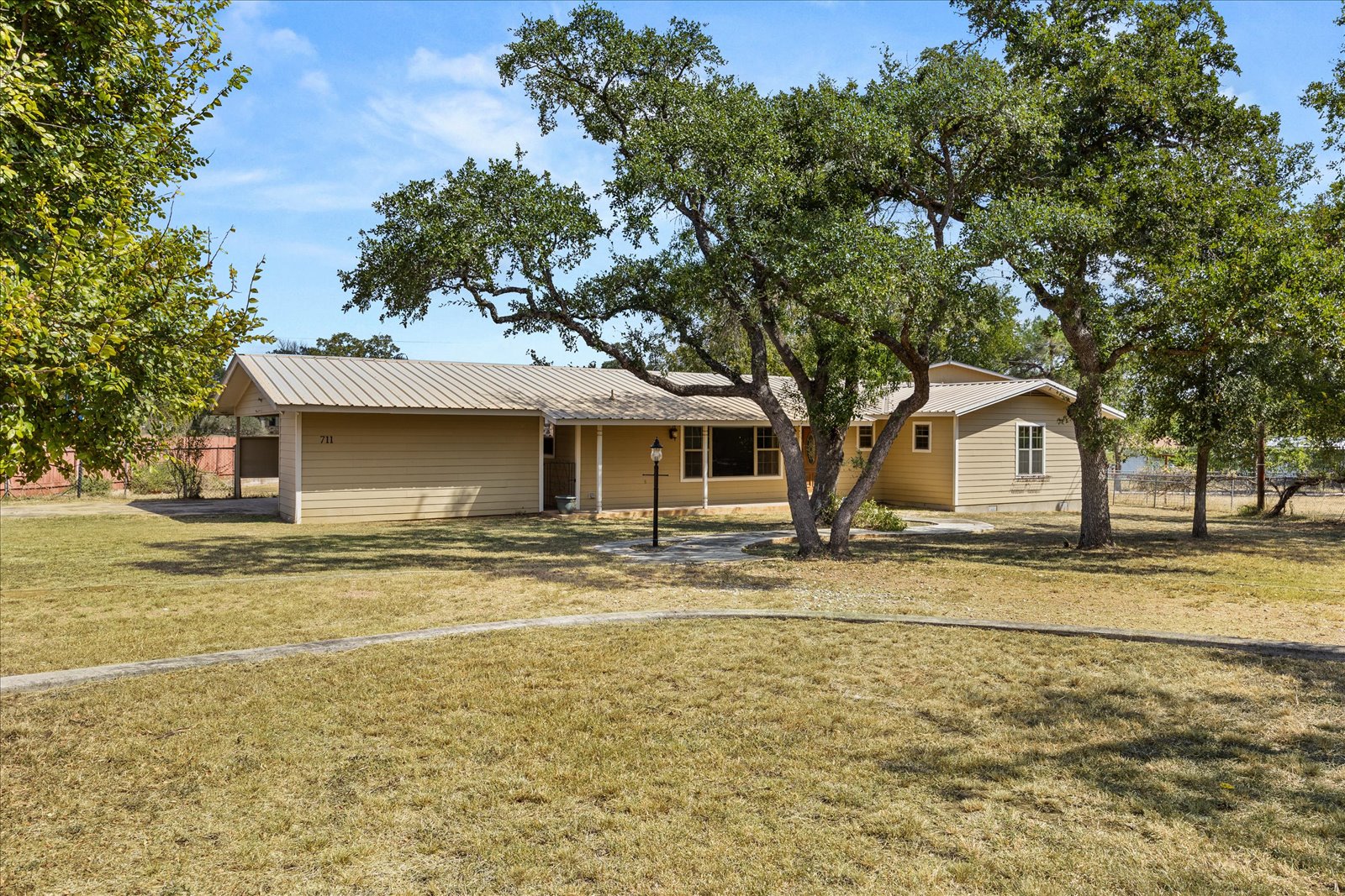 Ranch-style house featuring a metal roof