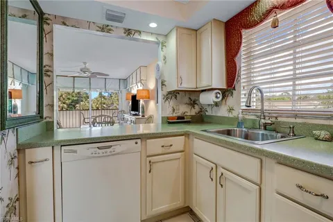 a kitchen with white cabinets and a sink