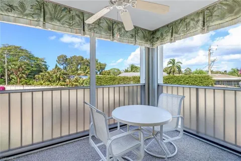 a view of a balcony with chairs and a table