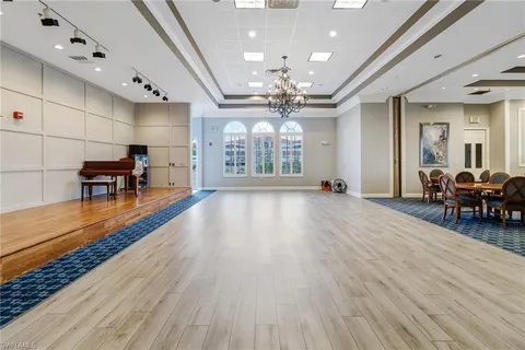 a view of a room with furniture and wooden floor