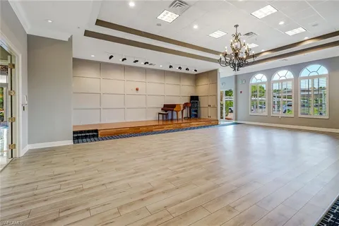 a view of a room with a window and wooden floor