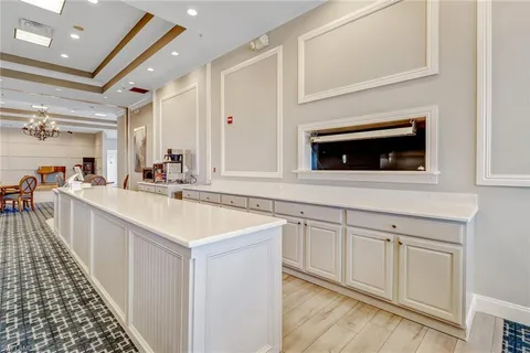a kitchen with granite countertop a sink and cabinets