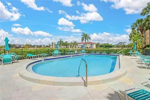 a view of a swimming pool with a yard