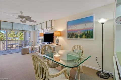 a dining room with furniture and a flat screen tv