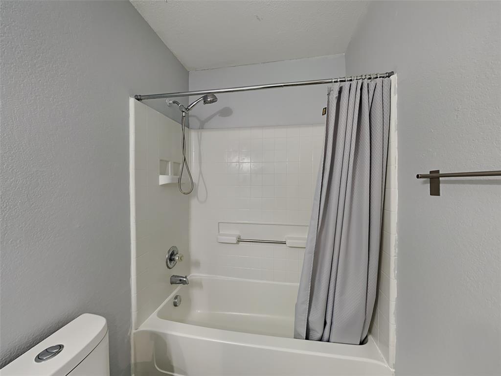 3808 Bandera Ranch Road Fort Worth, TX 76262 - Photo 13 of 15 a bathroom with a bathtub and a shower