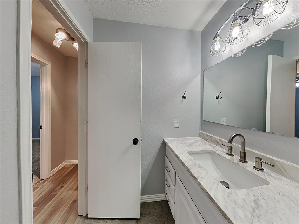 3808 Bandera Ranch Road Fort Worth, TX 76262 - Photo 14 of 15 a bathroom with a double vanity sink and mirror
