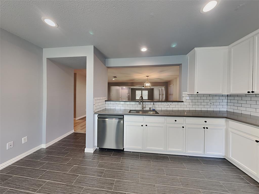 3808 Bandera Ranch Road Fort Worth, TX 76262 - Photo 3 of 15 a kitchen with granite countertop a sink and a stove top oven