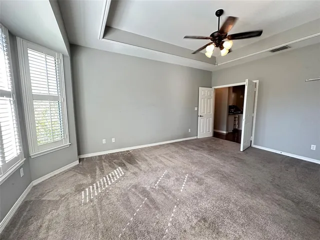 a view of a livingroom with a ceiling fan and window