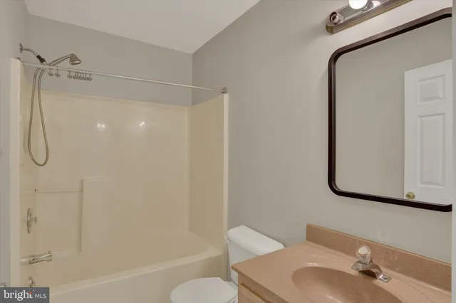 a bathroom with a shower curtain and a sink