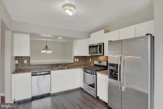 a kitchen with a refrigerator stove and sink