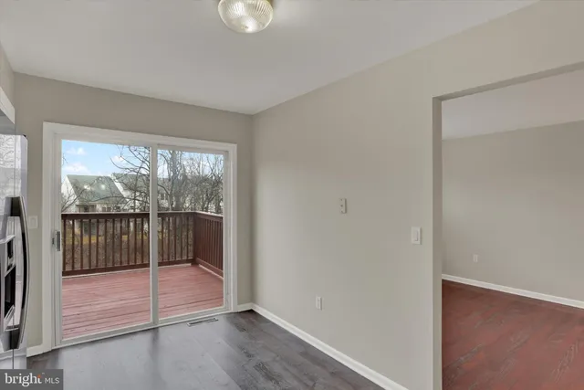 a view of a room with wooden floor and windows