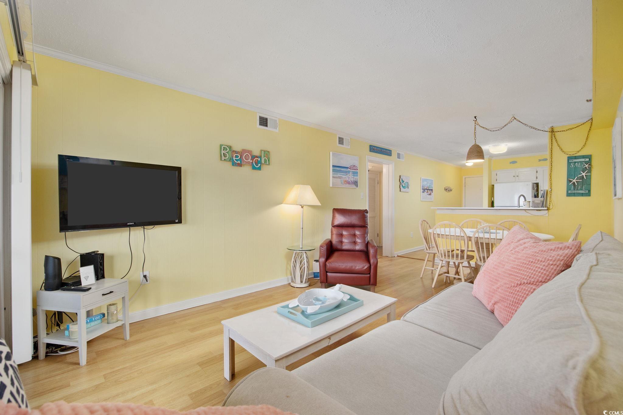 720 North Waccamaw Drive, Unit 301 Murrells Inlet, SC 29576 - Photo 11 of 37 Living room with light wood-type flooring and crown molding